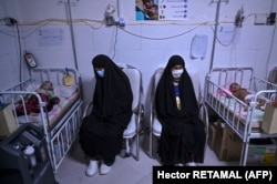 Women sitting next to their babies receiving treatment for malnutrition at a Doctors Without Borders (MSF) nutrition center in the western city of Herat in November.