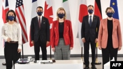 German Foreign Minister Annalena Baerbock (left), Italian Foreign Minister Luigi Di Maio (second from left), British Foreign Secretary Liz Truss (center), U.S. Secretary of State Antony Blinken (second from right) and Canadian Foreign Minister Melanie Joly pose for a group photograph during the G7 summit in Liverpool on December 12.