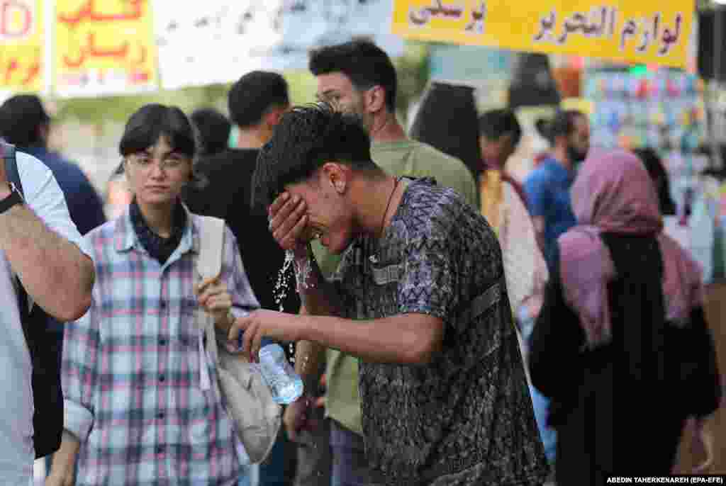 A boy tries to cool off with a bottle of water in Tehran. Ahvaz holds the record for Asia’s hottest official temperature of 54 degrees Celsius, which it recorded in 2017.  