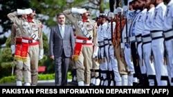 Pakistan's newly appointed caretaker prime minister, Anwaar-ul-Haq Kakar, is presented with a guard of honor at the President House in Islamabad on August 14.