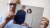 Taghi Ramahi, husband of Narges Mohammadi, poses with an undated photo of himself and his wife, during an interview at his home in Paris on October 6.