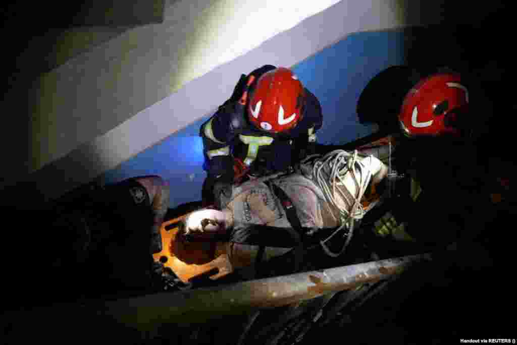 An injured person is removed from a residential building.  
