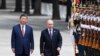 Chinese President Xi Jinpin (left) and Russian President Vladimir Putin as they review an honor guard during a visit to Beijing by the Russian leader last year. (file photo)