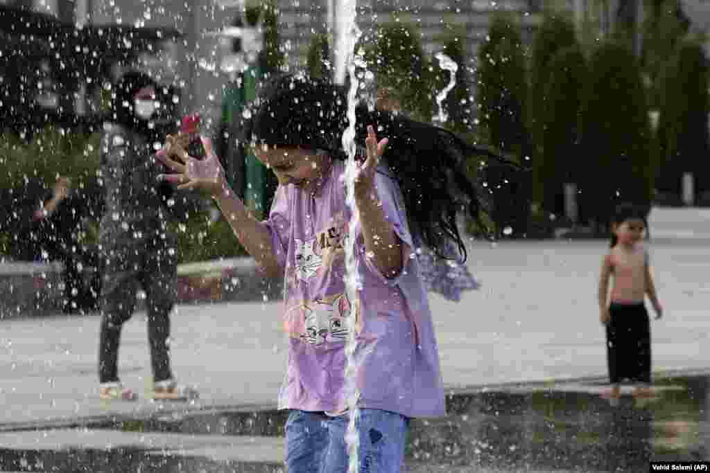 A young girl cools off in a water fountain at Tehran's Ebrahim Park as temperatures reached 38 degrees Celsius on August 1. State media reported temperatures had this week exceeded 51 degrees Celsius in the southern city of Ahvaz. 