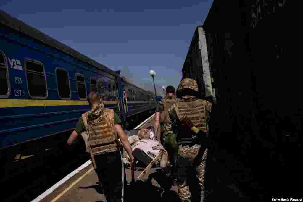 A wounded man is carried away from the train station.  Russia did not immediately comment on the incident. Moscow has stepped up air strikes in the past few days as Ukraine prepares for a counteroffensive, which Kyiv hopes will change the dynamic of Russia's more than 14-month-old war in Ukraine.