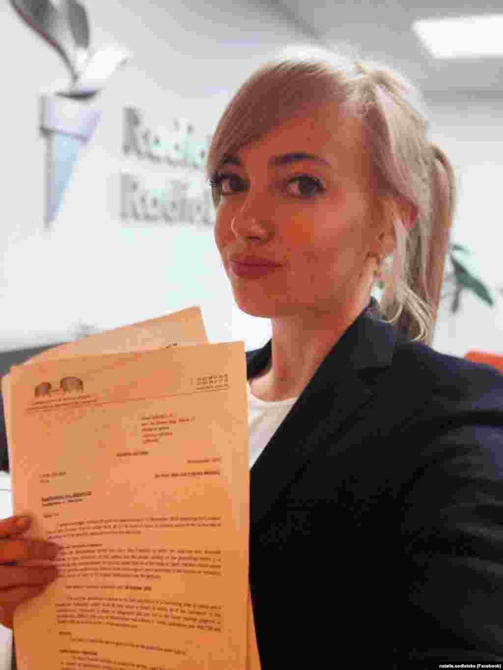 Керівниця проєкту розслідувань Радіо Свобода «Схеми» Наталія Седлецька із листом від Європейського суду з прав людини (ЄСПЛ), який зобов'язав владу України утриматися від доступу до будь-яких даних з її телефону. Суд відреагував на дії Генпрокуратури, яка хотіла отримати доступ до телефону журналістки. Київ, 18 вересня 2018 року