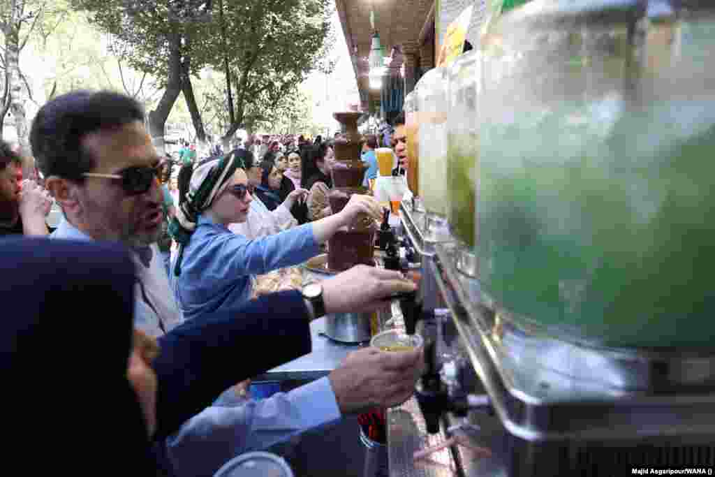 People in Tehran try to cool off with cold drinks. With its rivers and lakes drying up and prolonged droughts becoming the norm, the heat wave is highlighting a water crisis in Iran that is turning much of the country’s territory to dust.