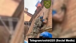 Бійці ЗСУ скидають російський прапор на одній з адміністративних будівель населеного пункту Курської області. РФ, серпень 2024 року