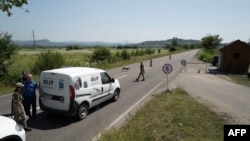Ukrainian border guards stop vehicles on a road near the Romanian border to try to identify possible deserters. July 10, 2024.