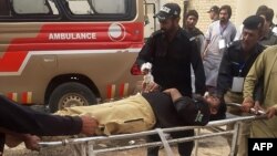 Police officers carry an injured colleague on a stretcher following a bomb blast in Sibi, a city in the southwestern Pakistani province of Balochistan, on March 8.