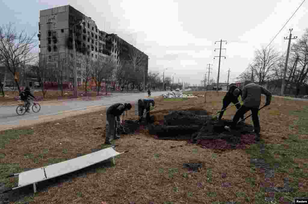 Graves are prepared for victims killed during Russia's assault on the city. Many corpses have been left where they fell for long periods because it was too dangerous to collect and bury them.