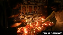 Mourners pay tribute at Karachi's Confucius Institute on April 28 to those killed by a suicide bomber.