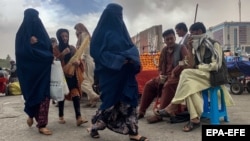 Afghan women walk on a street in the capital, Kabul, on May 10.