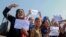 Afghan women shout slogans during a protest to demand the Taliban-led government allow the reopening of girls' schools and to provide ample employment opportunities, in Kabul on October 21.