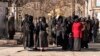 Afghan female students are stopped by Taliban security personnel stand next to a university in Kabul on December 21.