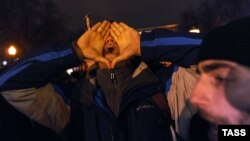 An opposition activist shouts slogans during the rally in central Moscow