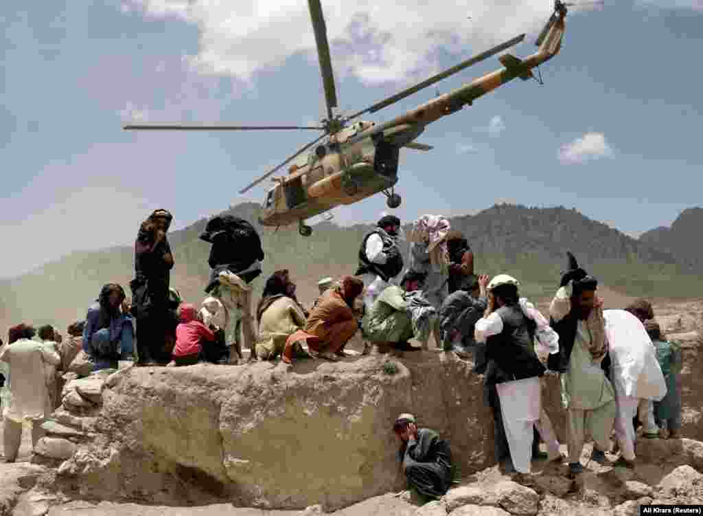 A Taliban helicopter takes off after bringing aid to Gayan. The United Nations said it was deploying medical health teams and supplying medicines, but it said it does not have search-and-rescue capabilities in Afghanistan.  