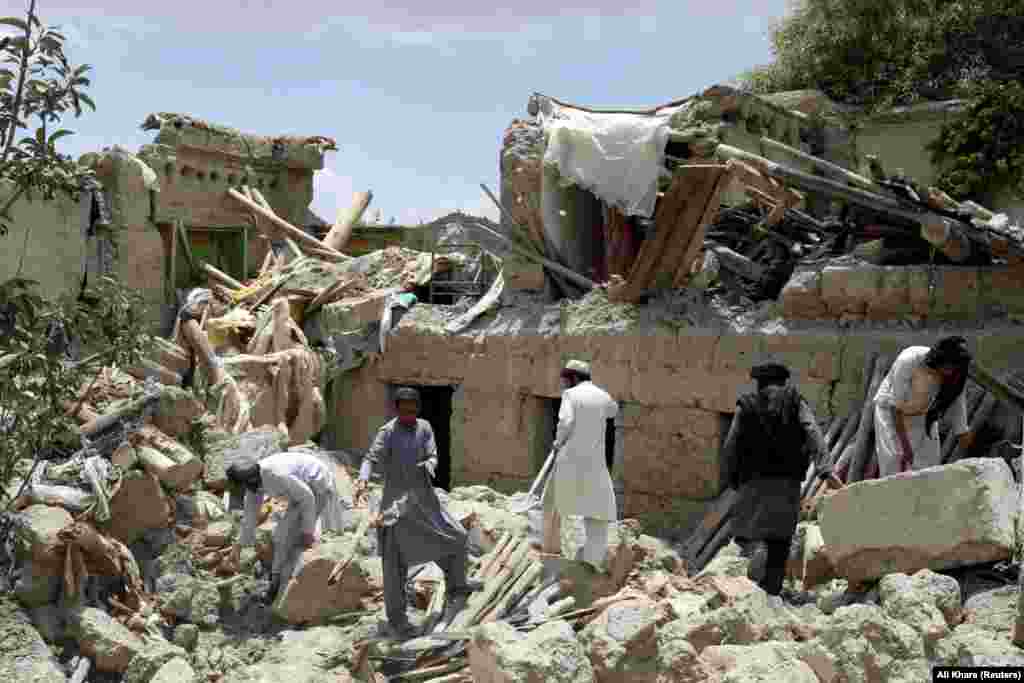 Afghan men search for survivors amid the rubble of a house destroyed by the earthquake, on June 23 in Paktika Province's Gayan district. The Taliban declared the search for survivors to be over on June 24. The disaster poses a challenge for the Taliban-led government, which is largely isolated as a result of its hard-line Islamist policies toward women and girls. The country had already been battling a severe humanitarian crisis after crucial foreign aid was halted following the Taliban takeover in August 2021. 