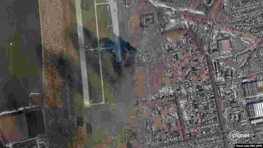 A satellite photo released by Planet Labs PBC shows smoke rising after an explosion at the Chuhuiv airfield.  