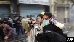 A protester is carried away during clashes with security forces Tahrir Square in Cairo on November 21.
