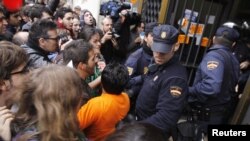Spanish protestors clash with police a during a 24-hour nationwide general strike in Valencia on November 14.