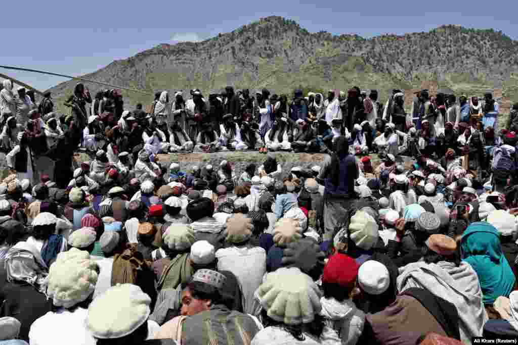 People wait to receive aid in Gayan, which was devastated by the June 22 earthquake. The quake was the deadliest in the country since 2002, when a similarly powerful tremor killed about 1,000 people in northern Afghanistan.