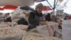 A woman sells dried curds at the central market in Bishkek, back to normal after April's violence.