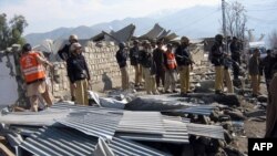 Pakistani police inspect the site of the blast
