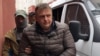 Vladislav Yesypenko, a freelance contributor to RFE/RL, is detained by FSB officers in Crimea on March 16.