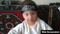 A young baby wearing an Islamic State headband. This photo was posted on the Russian social network VKontakte by a man named Artyom from Kazakhstan who says he is fighting for IS.