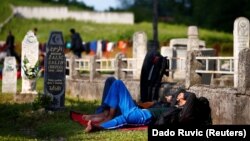 Migrants sleep at a cemetery close to Velika Kladusa, a town in Bosnia close to the border with Croatia. (file photo)