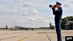 A Russian Air Force officer takes photos of the joint Russian-Serbian military exercises at an airport in Batajnica, near Belgrade, on October 13.
