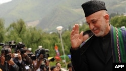 Afghan President Hamid Karzai arrives at the 16th South Asian Association for Regional Cooperation summit in Thimphu, Bhutan