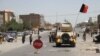 Afghan security officials and private militia members patrol in Herat on August 4.