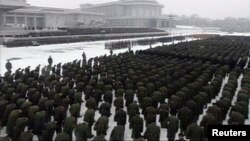 Uniformed personnel stand in formation outside the Kumsusan Memorial Palace during Kim Jong Il's funeral procession in Pyongyang
