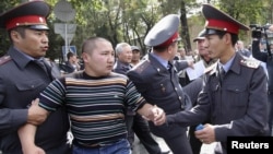 Police detain a protester during an opposition rally in Bishkek.