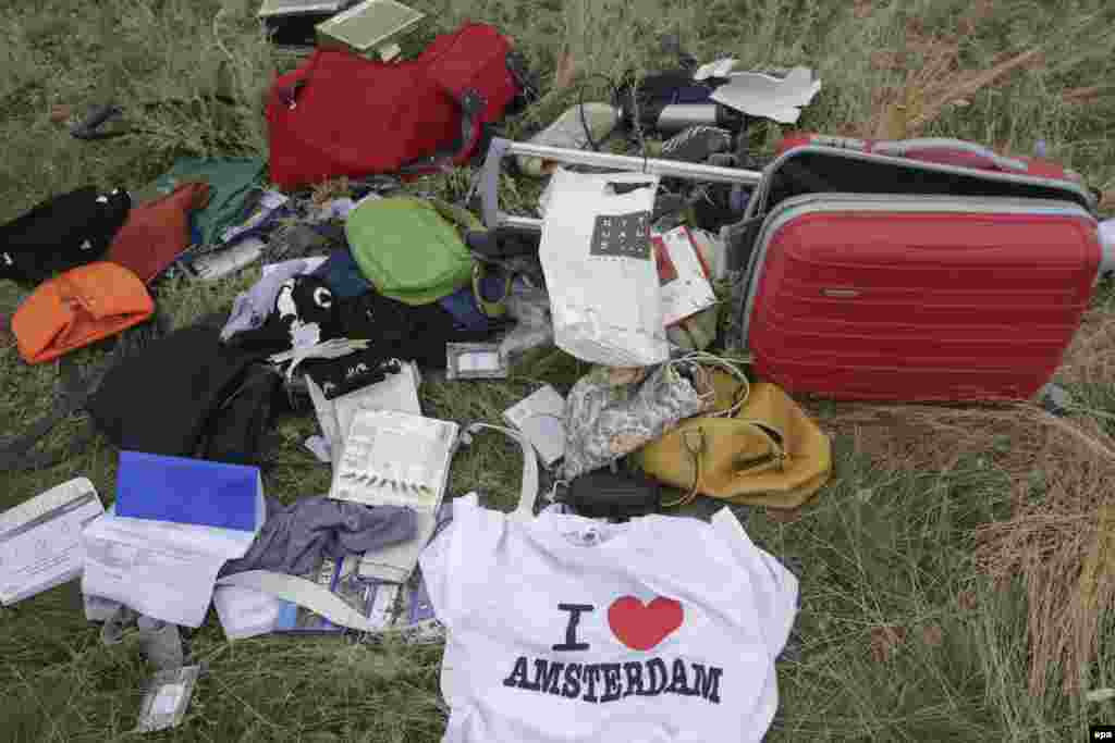 Passengers' personal belongings and luggage amid the debris of the Boeing 777 jet. 
