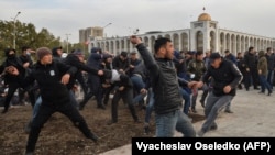 Supporters of politician Sadyr Japarov clash with supporters of former Kyrgyz President Almazbek Atambaev in Bishkek on October 9.