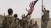 U.S. troops take down their country's flag as part a ceremony held to hand over an American base to local defense forces in May. Afghanistan was overrun by the Taliban just a few months later, shortly before the United States had fully completed its withdrawal.