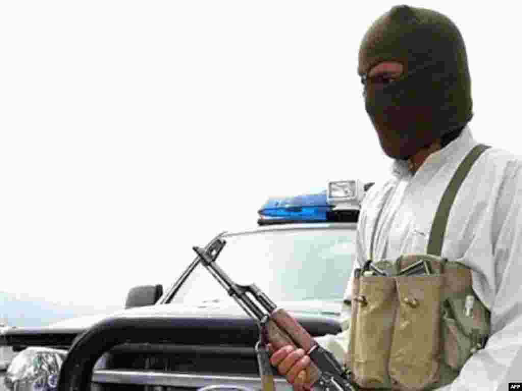 A masked tribesman patrols near Wana, in South Waziristan, where torrid fighting that pitted tribesmen against Uzbek and other foreign militants in March 2007 left more than 100 dead - Almost from the outset of the post-Taliban insurgency that began in 2002-03, Kabul has accused Islamabad of supporting the insurgents, or at least of failing to prevent their activities inside Pakistan.