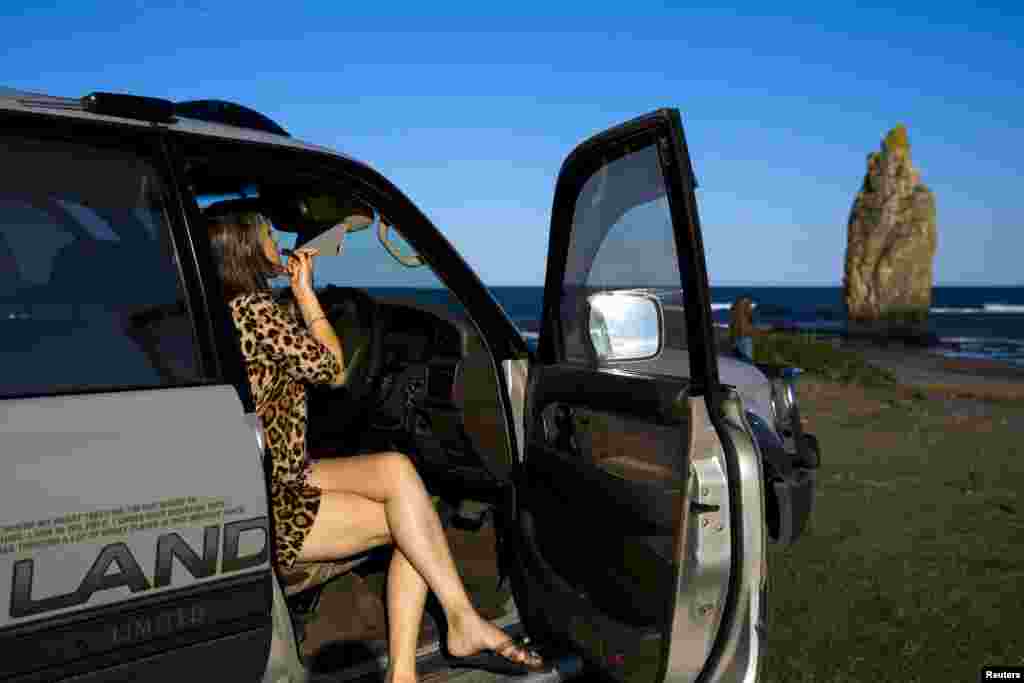 A Russian woman touches up her lipstick on Kunashir. The dispute over the islands means a peace treaty has never been signed between Russia and Japan to formally end World War II hostilities. As one local woman put it, "There is no war, but there is no peace either."