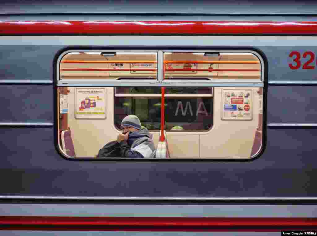 A man covers his face inside the subway. The Czech government has banned most nonessential travel throughout the country. 