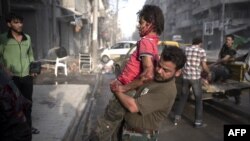 A fighter injured in the Arqub neighborhood of northern city of Aleppo is brought to a hospital on October 1.
