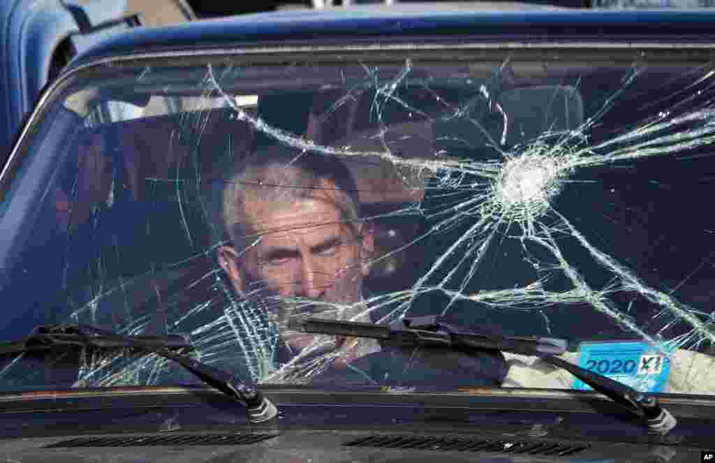 A passenger waits as his car is searched at a checkpoint while leaving Nagorno-Karabakh on November 8. 