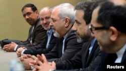 Iranian Foreign Minister Mohammad Javad Zarif (center), flanked by members of his delegation, attends talks over Iran's nuclear program in Geneva on November 22.