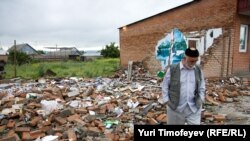 A man walks by the ruins of a shop destroyed by militants in Ingushetia. Russia is struggling to quell an Islamic insurgency in the region.