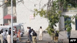 Police and rescue workers attend to victims of the suicide bombings near Islamabad.