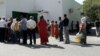 Long lines of people wait in front of a grocery store in Ashgabat to buy vegetable oil, sugar, and flour in late May.
