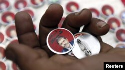 Badges showing an image of President Muhammad Morsi and the words "Yes To Constitution" are displayed at a street stall in Cairo.