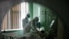 Russian medics treat a patient suffering from COVID-19 in the intensive care unit of a hospital in the Russian city of Orel.